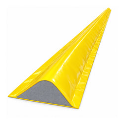 High-visibility yellow PVC-coated foam core drive-over bunding kit laid across a warehouse roller door threshold for spill containment.