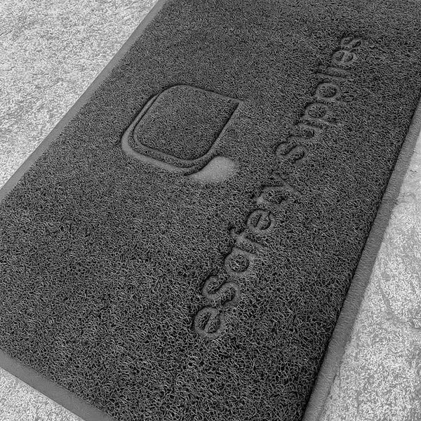 The textured surface is specifically designed to trap dirt, mud, and moisture, while the anti-slip backing ensures the mat stays securely in place to prevent bunching or sliding.