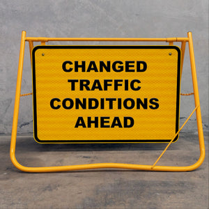 Flat-folding yellow swing stand sign frame for easy transport in site utes and vans, featuring a durable metal sign face and removable bolts.