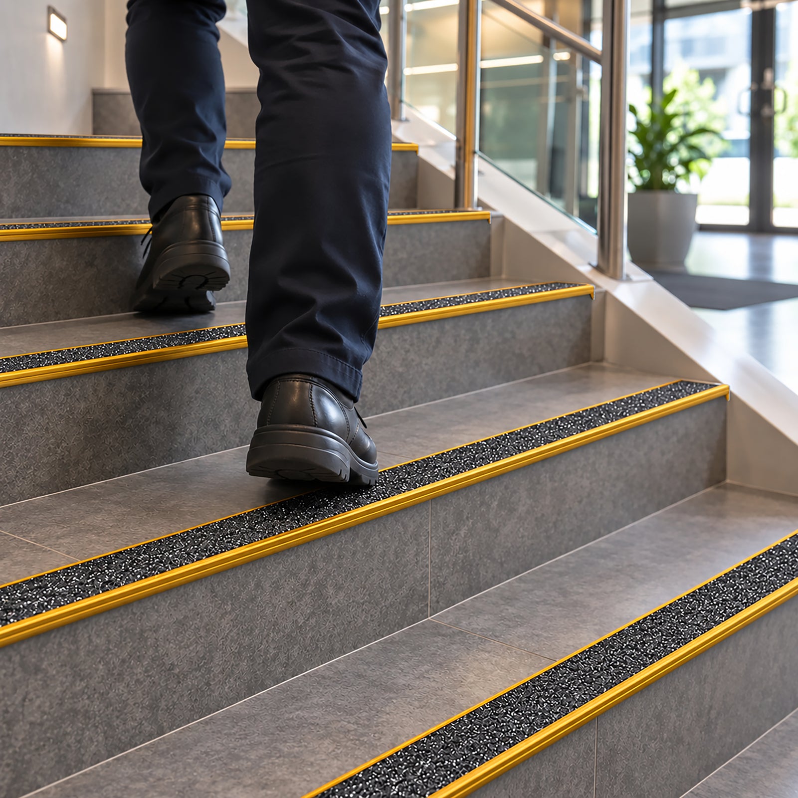 63mm clear anodised aluminium stair nosing with a pre-applied black carborundum anti-slip insert and a 10mm front drop.