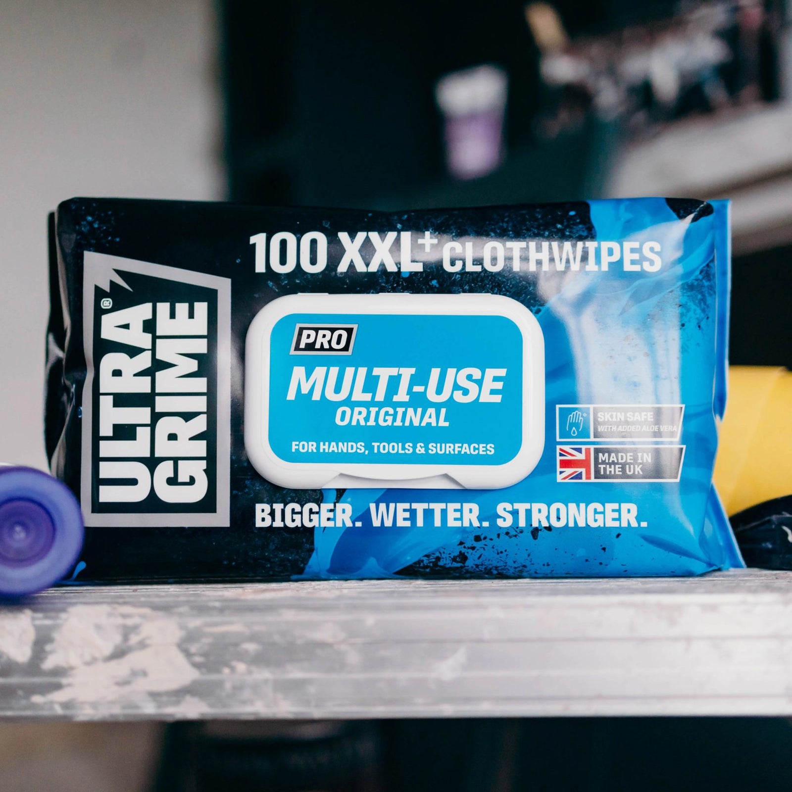 Extra-Large Cleaning Wipes being used to clean tools and machinery in a workshop environment, demonstrating heavy-duty performance.