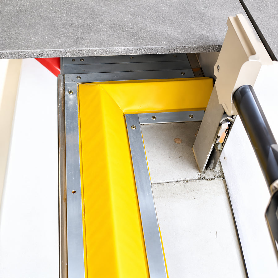 L-shaped 90-degree corner joint piece made from memory foam with a durable yellow PVC outer layer for chemical containment perimeter mapping.